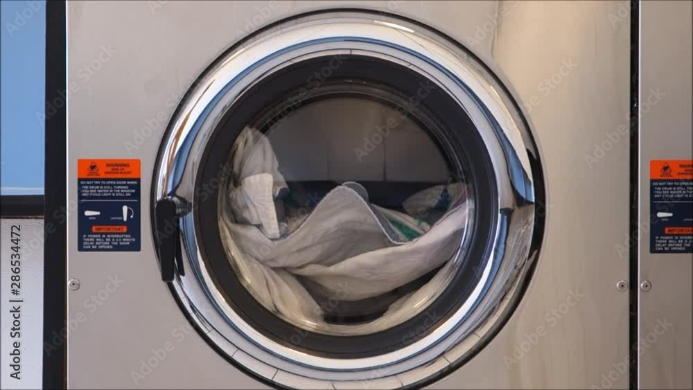public laundry with clothes inside washing machine public laundry with clothes inside washing machine