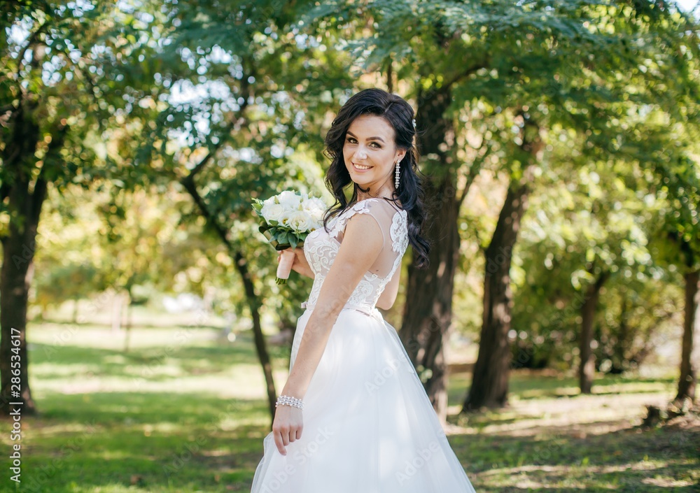Beautiful bride with stylish make-up in white dress 