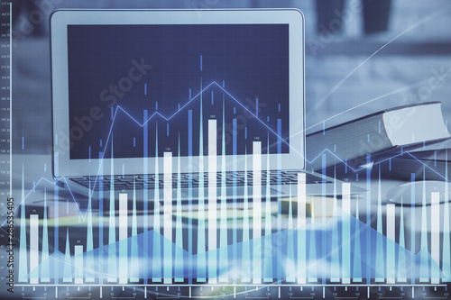 Stock market chart hologram drawn on personal computer background. Multi exposure. Concept of investment. © peshkova
