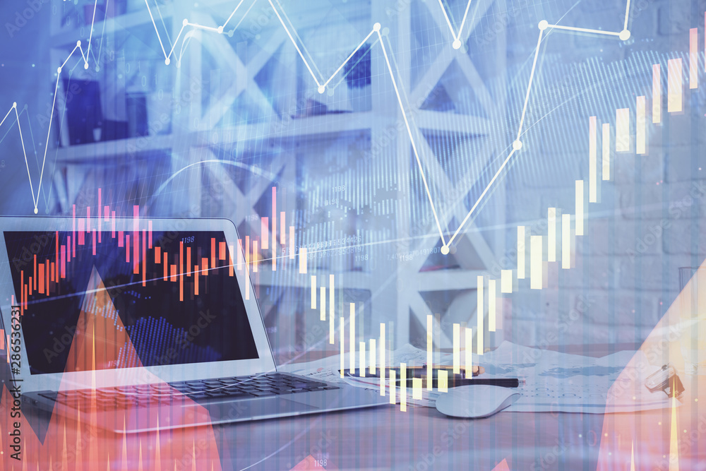 Fototapeta premium Stock market chart hologram drawn on personal computer background. Multi exposure. Concept of investment.