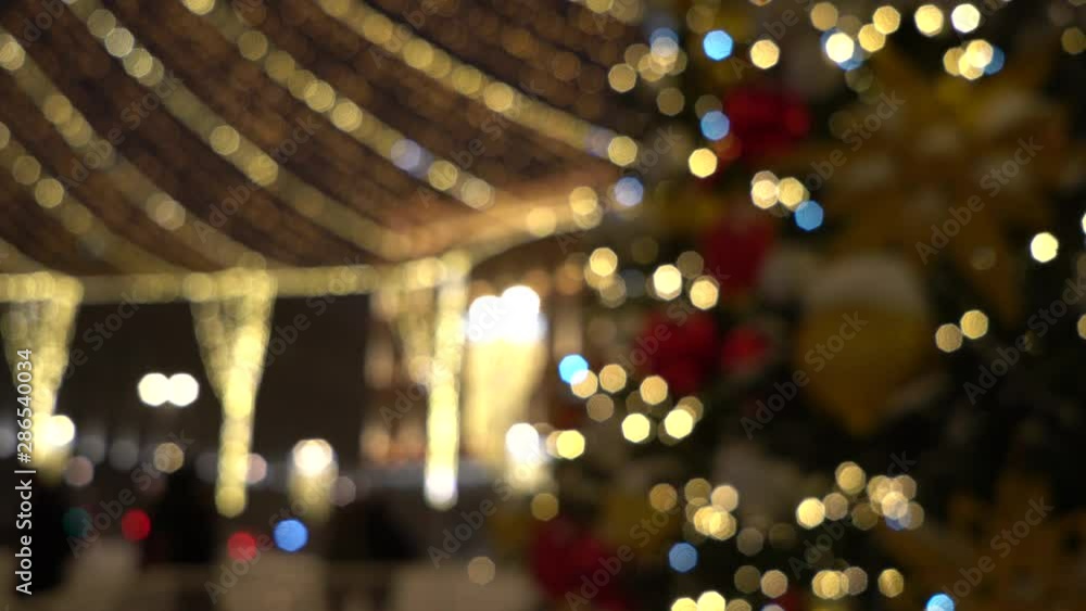 Christmas tree sparkles with colorful lights. Blurred christmas background with bokeh Christmas tree sparkles with colorful lights. Blurred christmas background with bokeh