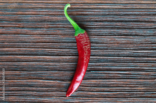 Red hot chili peppers on a wooden board close-up.