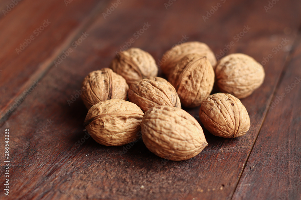 Walnuts isolated on the old wooden background Walnuts isolated on the old wooden background