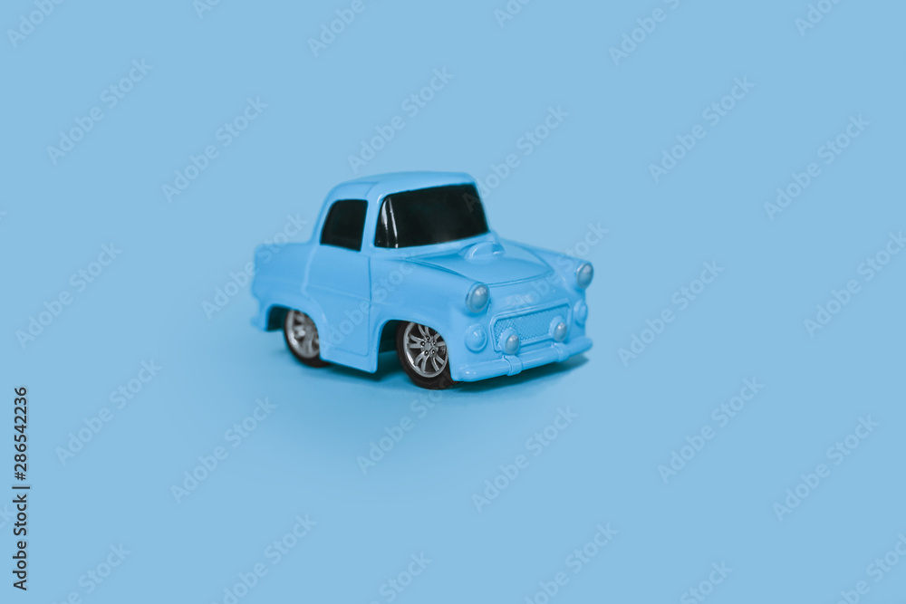 blue retro toy car on an isolated blue background blue retro toy car on an isolated blue background