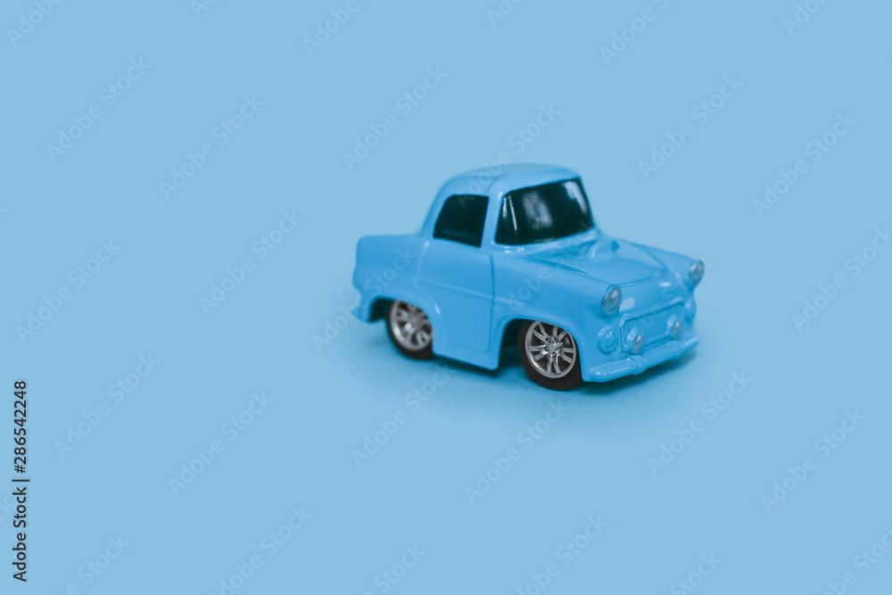 blue retro toy car on an isolated blue background blue retro toy car on an isolated blue background