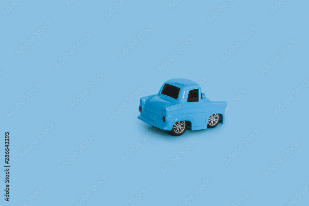 blue retro toy car on an isolated blue background