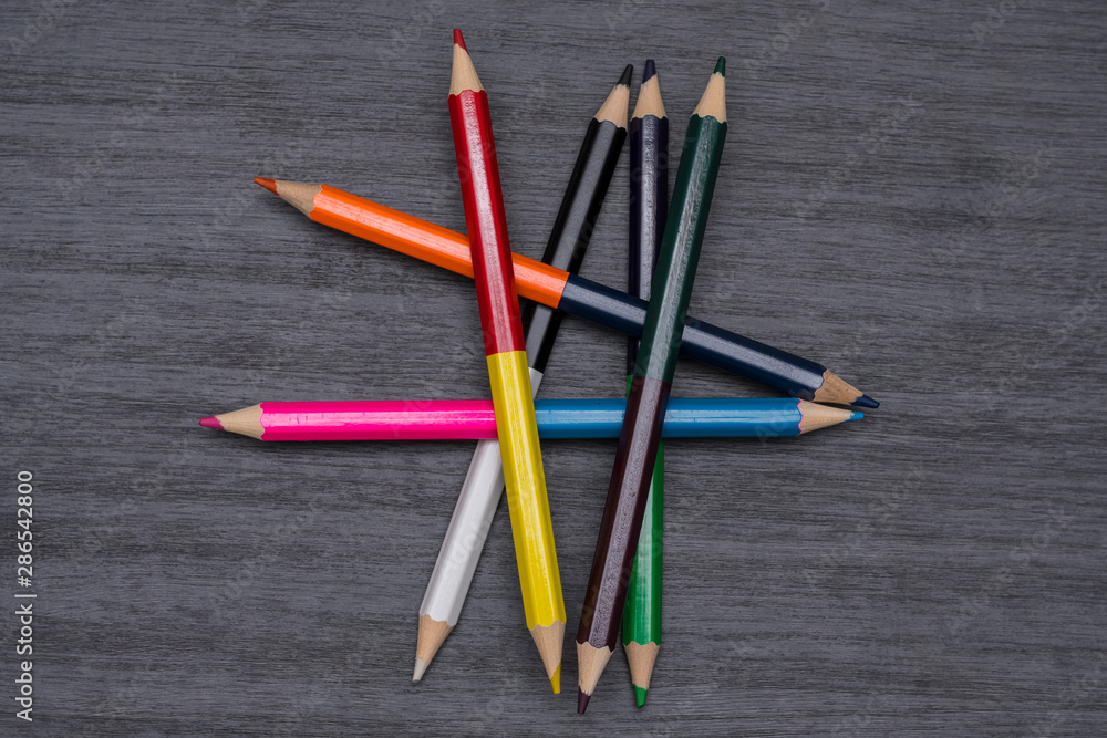 Colored pencils isolated on dark wooden background Colored pencils isolated on dark wooden background
