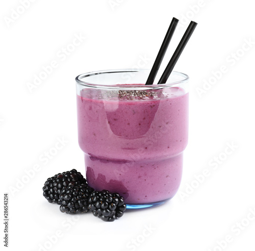 Delicious blackberry smoothie in glass with straws on white background