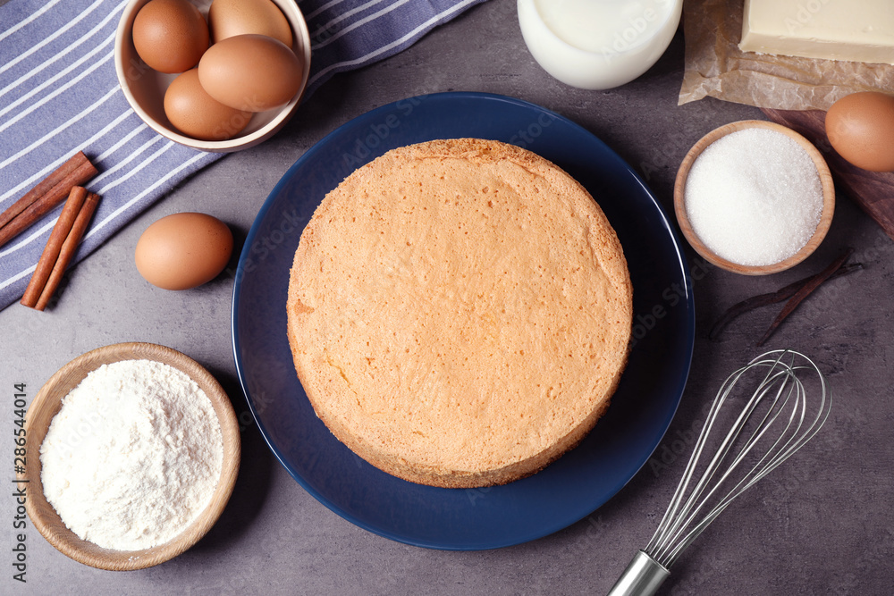 Flat lay composition with delicious fresh homemade cake on grey marble table