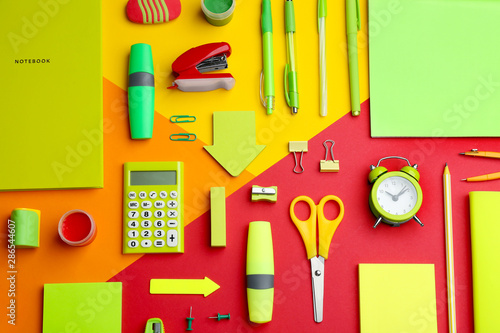 Different bright school stationery on color background  flat lay