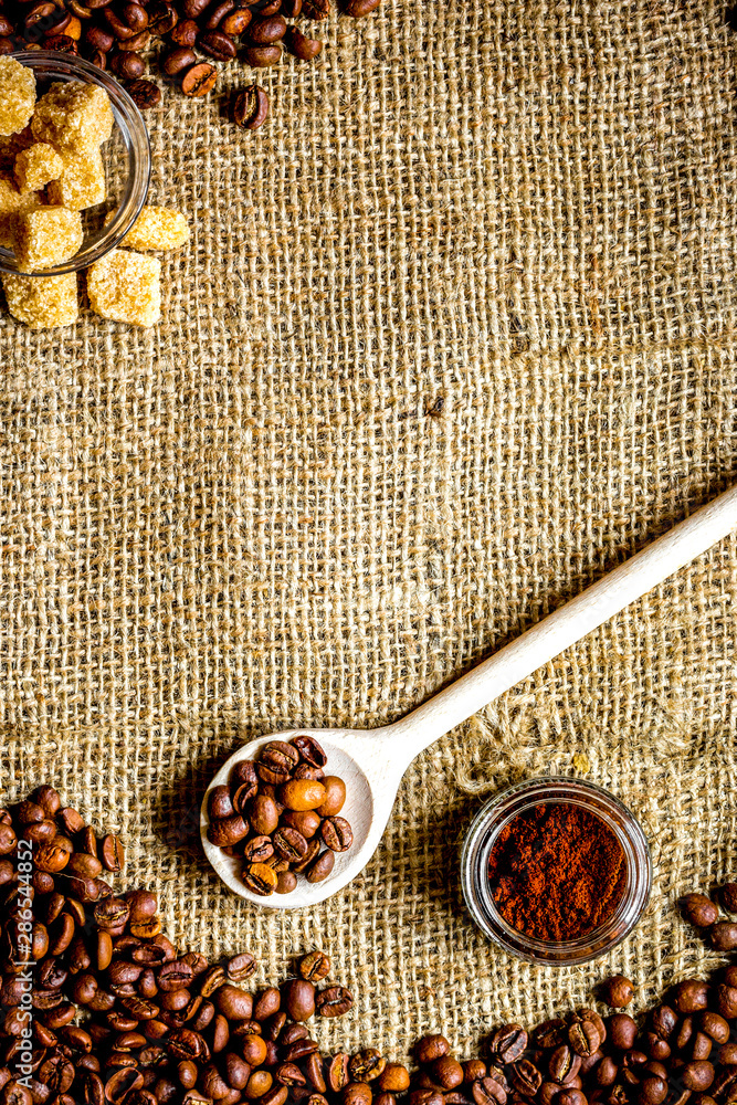 beans, ground coffee and sugar cane on linen cloth beans, ground coffee and sugar cane on linen cloth