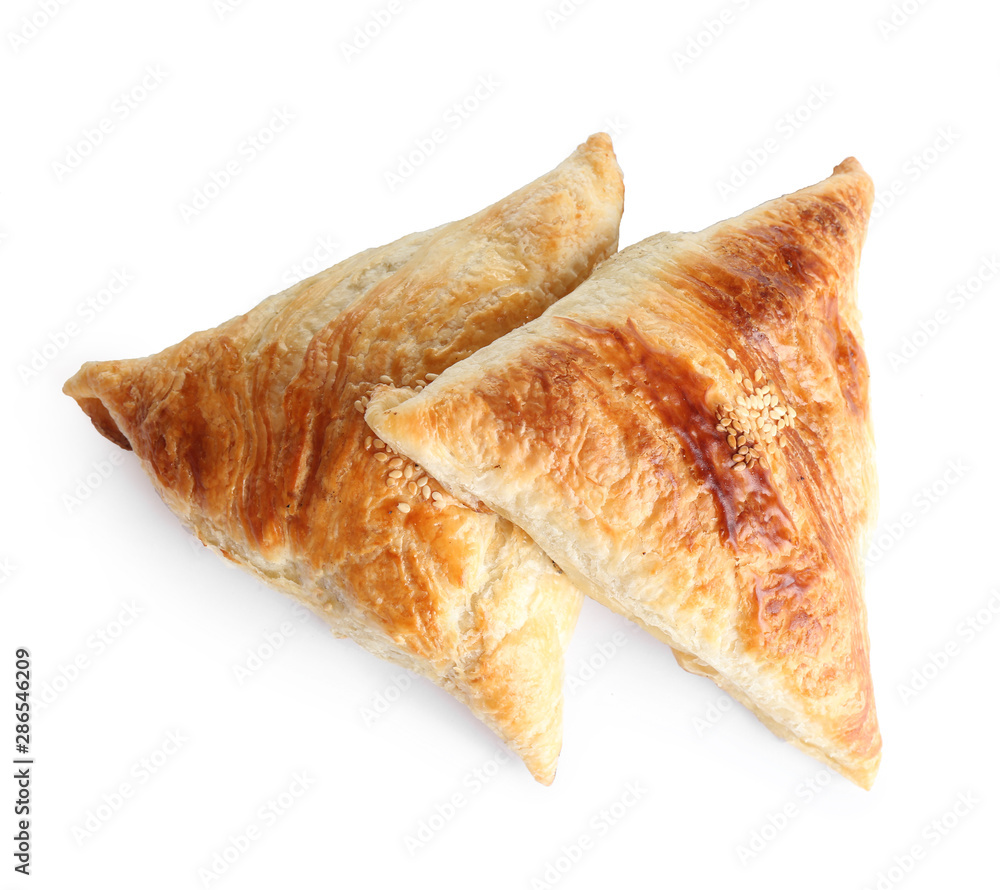 Fresh delicious puff pastry on white background, flat lay
