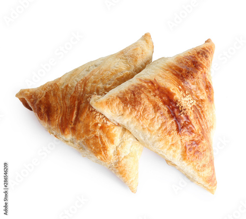 Fresh delicious puff pastry on white background, flat lay