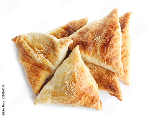 Fresh delicious puff pastry on white background  flat lay