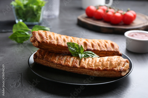 Fresh delicious puff pastry served on grey table