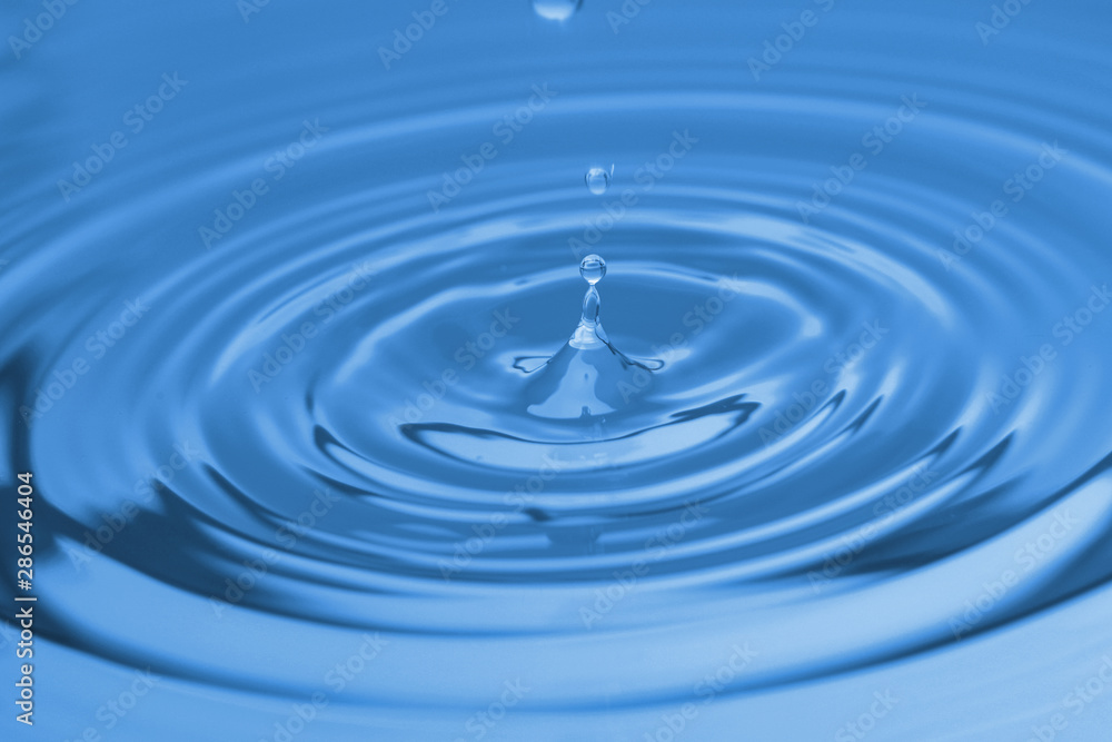 Splash of blue water with drop, closeup