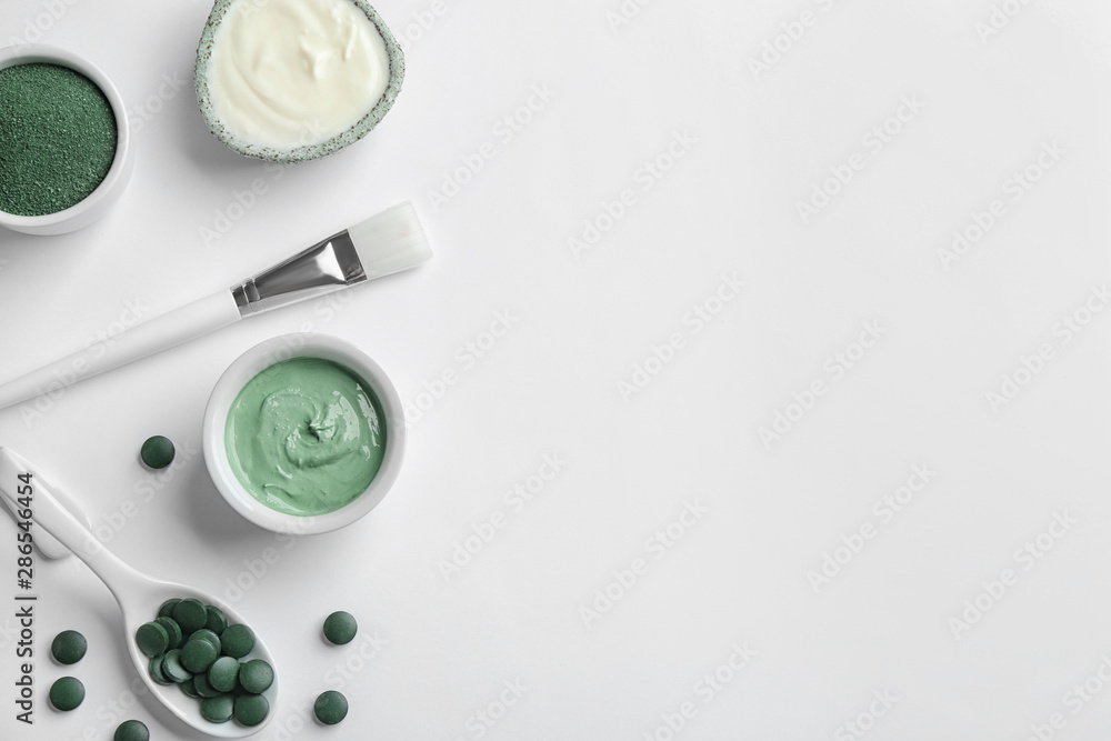 Composition with spirulina facial mask and ingredients on white background, top view Composition with spirulina facial mask and ingredients on white background, top view