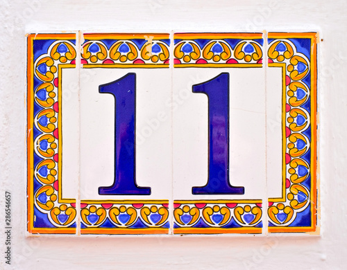 Number 11 / eleven, ornamental tiles on white background. photo