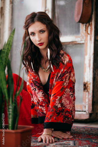 Portrait of beautiful young brunette woman with makeup in bright clothing