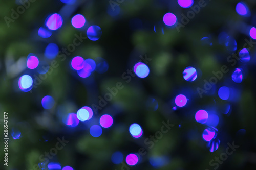 Abstract background with blurred violet Christmas lights, bokeh effect