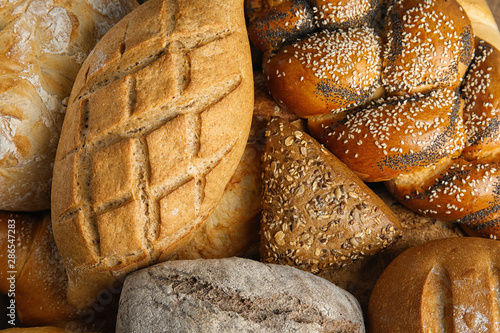 Fresh breads and pastry as background, top view