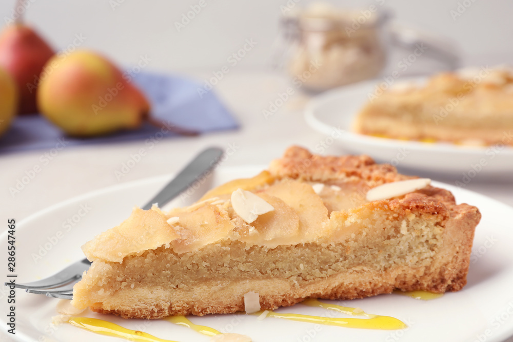 Piece of delicious sweet pear tart on table, closeup Piece of delicious sweet pear tart on table, closeup
