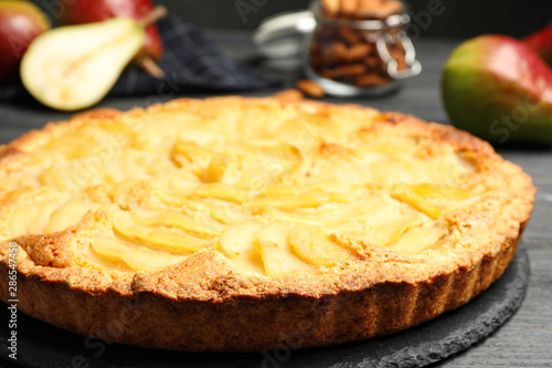 Delicious sweet pear tart on table, closeup