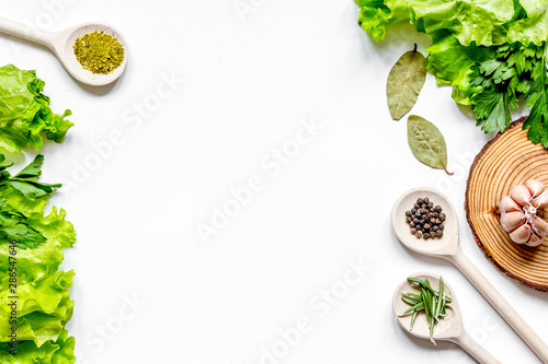 frame spices and fresh herbs on white table top view