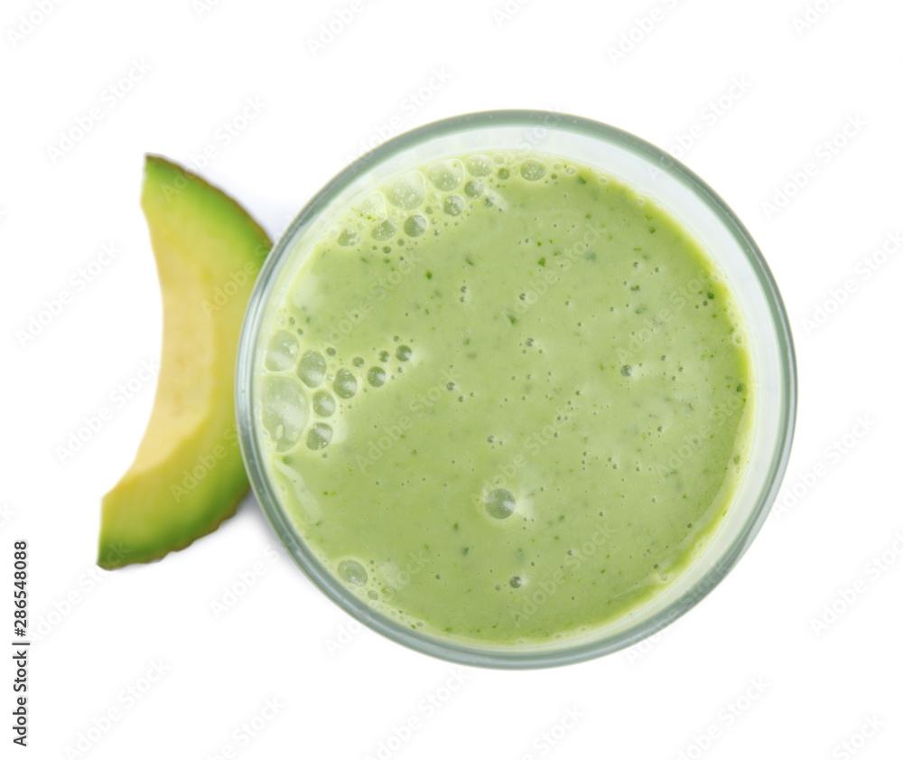Glass of tasty smoothie and avocado slice on white background, top view Glass of tasty smoothie and avocado slice on white background, top view