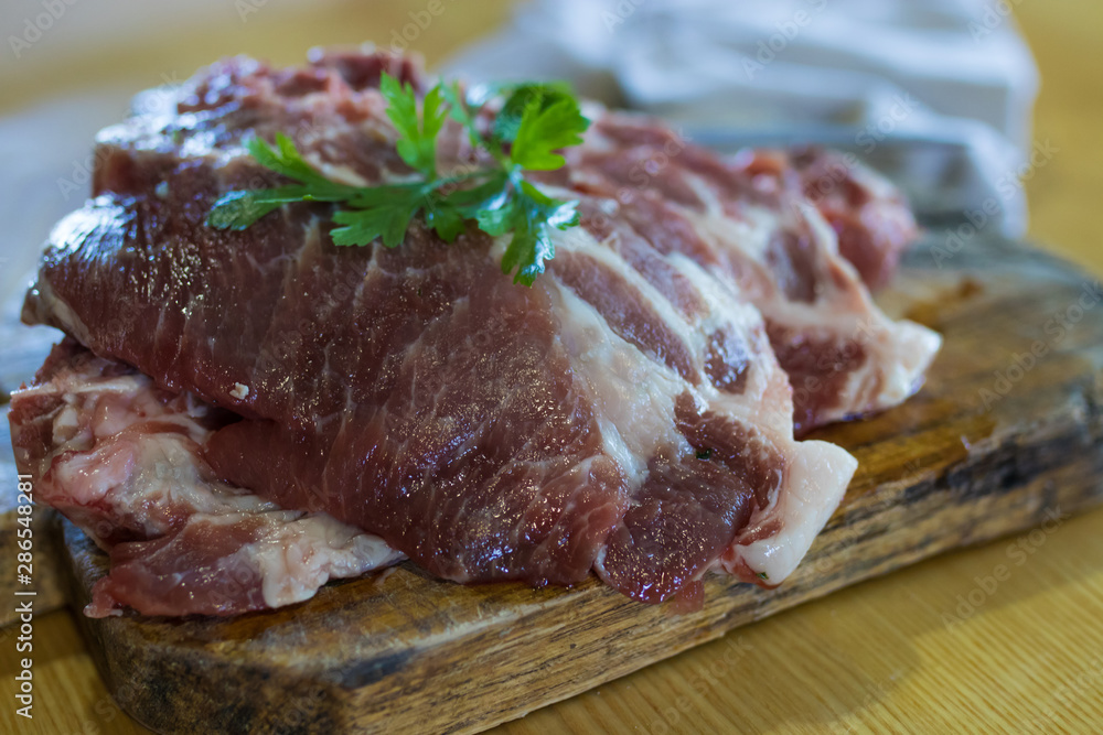 fresh veal chop meat on wood