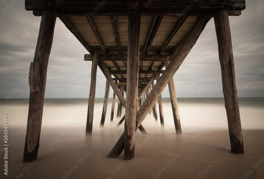 Old wooden fishing pier out to ocean