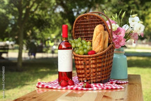 Fototapeta Naklejka Na Ścianę i Meble -  Composition with picnic basket on table outdoors