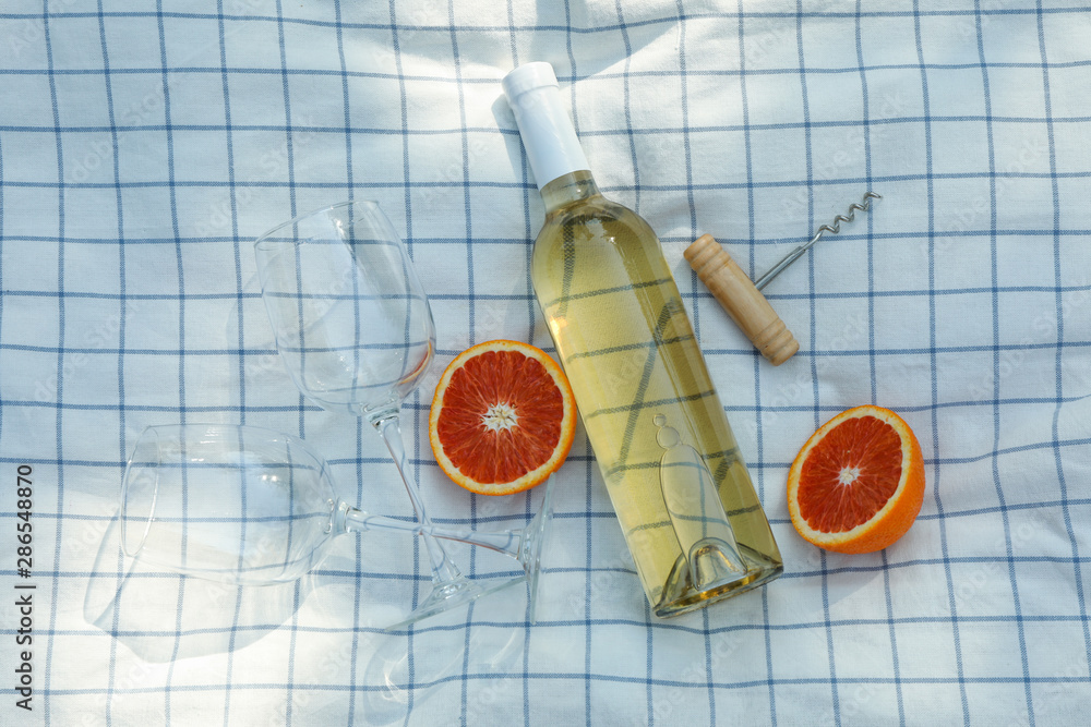 Bottle of wine, glasses, orange and corkscrew on towel, space for text Bottle of wine, glasses, orange and corkscrew on towel, space for text