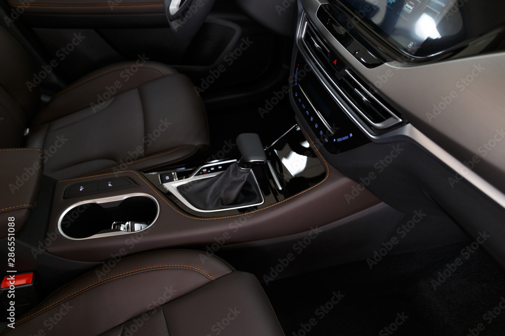 Part of stitched leather black leather car interior. Modern luxury car black perforated leather interior. Car leather interior details