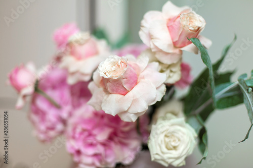 Wedding decorations. Holiday decoration vase with fresh flowers. Pink roses and carnations. © Kate