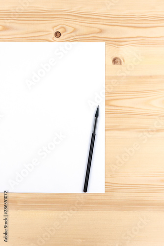 Pencil on white paper list on a wooden desk with copy space