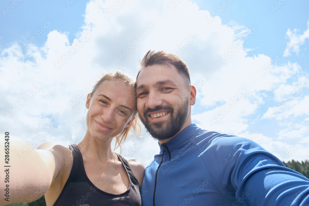 Couple photographing themselves while hiking in summer Couple photographing themselves while hiking in summer