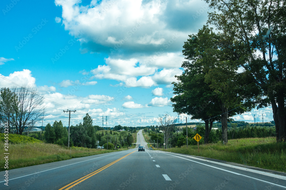 Fototapeta premium The road with a panoramic view of the fields