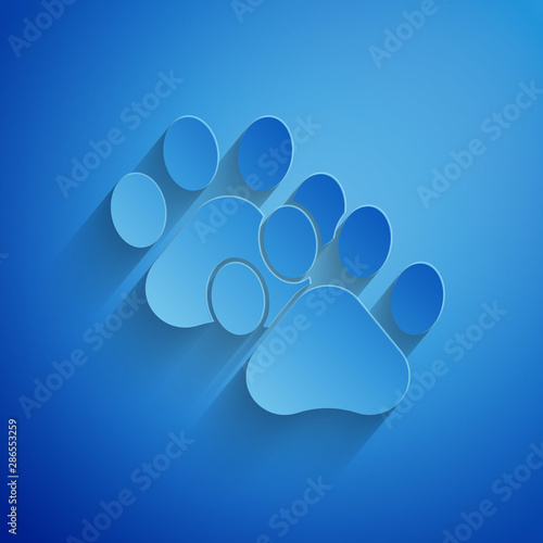 Paper cut Paw print icon isolated on blue background. Dog or cat paw print. Animal track. Paper art style. Vector Illustration