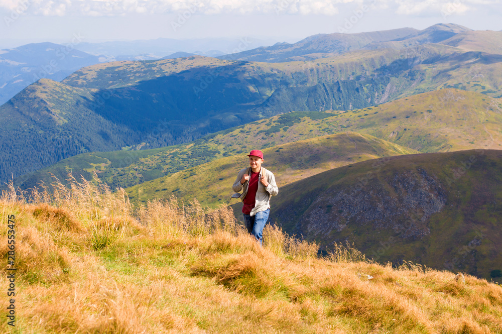 guy with a backpack travels in the mountains