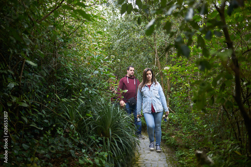 Tourists exploring a wild vegetation zone with a path on it © Ruben Chase