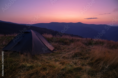 Beautiful mountain landscape with a tourist tent. Carpathian mountains of Ukraine. Holidays in the mountains.