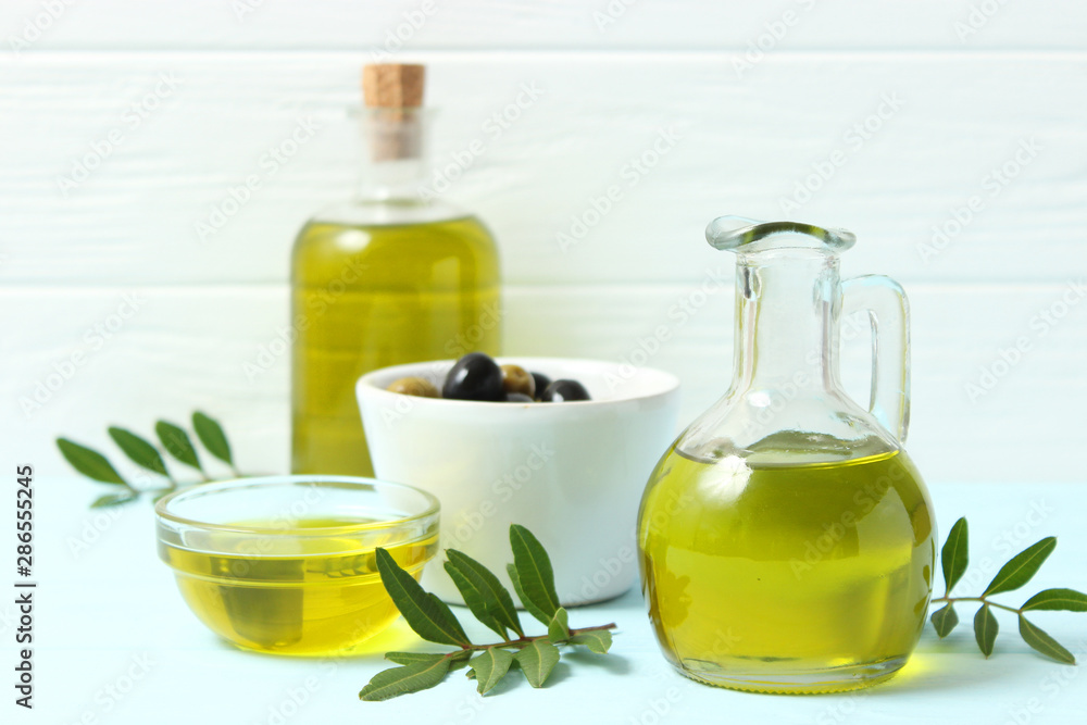 olive oil, green leaves and olives on the table. olive oil, green leaves and olives on the table.