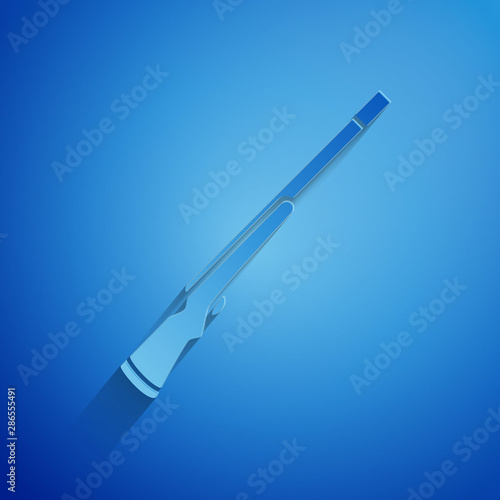 Paper cut Hunting gun icon isolated on blue background. Hunting shotgun. Paper art style. Vector Illustration