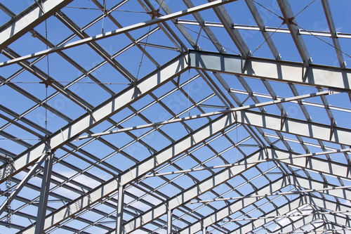 Steel structure of building construction on blue sky background