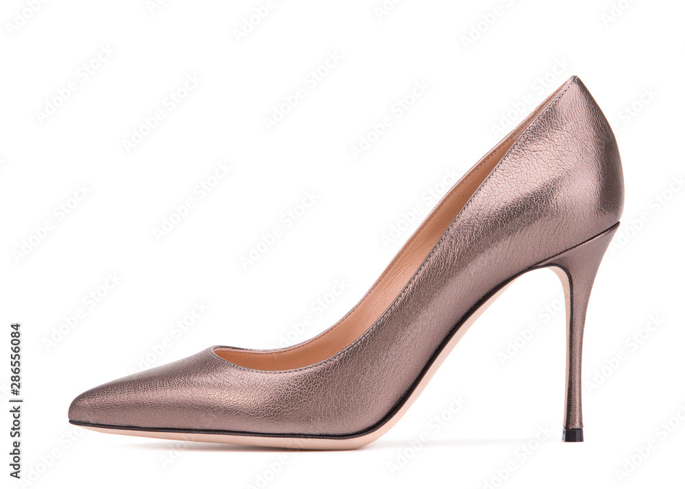 Obraz premium High-heeled shoes in bronze color. Elegant heeled shoes with a tapered cape. Beautiful pumps shoes in profile isolate on a white background.