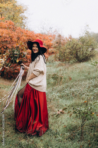 Beautiful girl in red hat in autumn garden © Forewer
