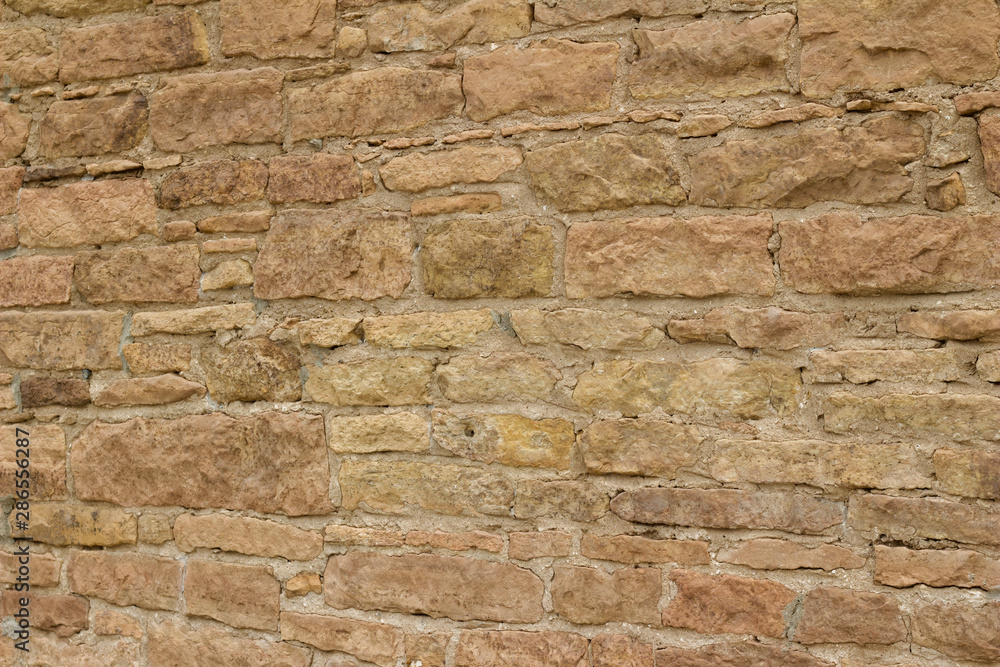 Antique light brown limestone wall texture with thick mortar and grunge look