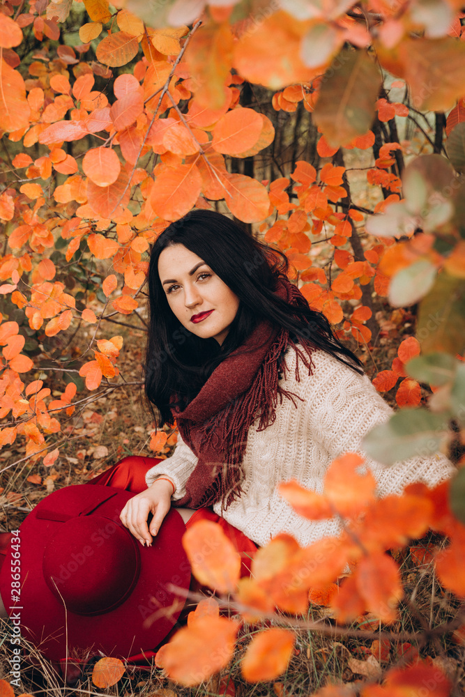 Beautiful girl in red hat in autumn garden Beautiful girl in red hat in autumn garden
