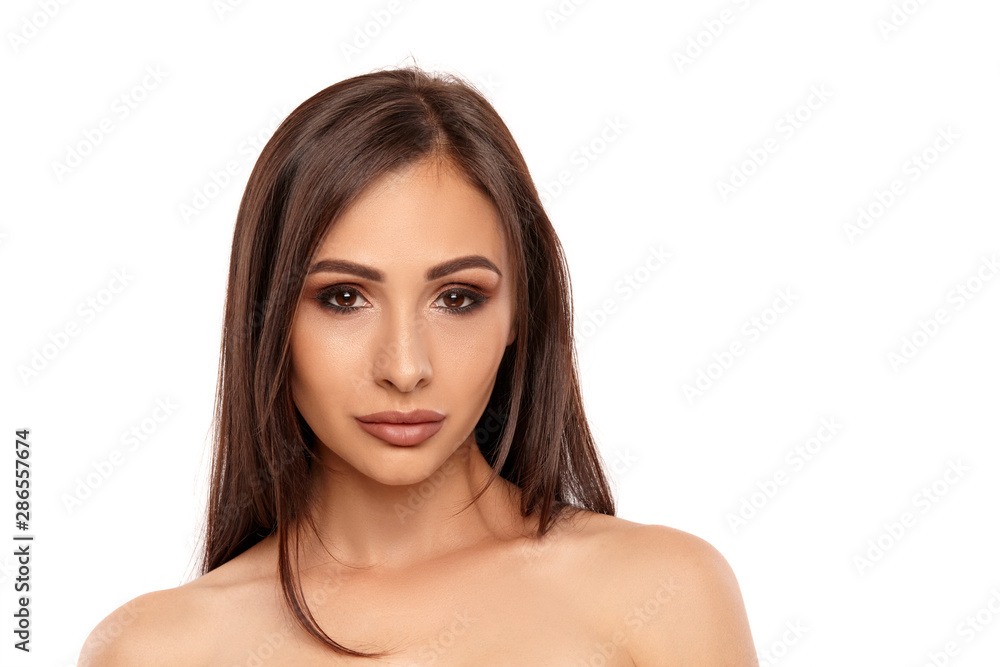 Close up portrait of a brunette nude model girl with professional evening make-up and plump lips, posing isolated on white background. Close up portrait of a brunette nude model girl with professional evening make-up and plump lips, posing isolated on white background.
